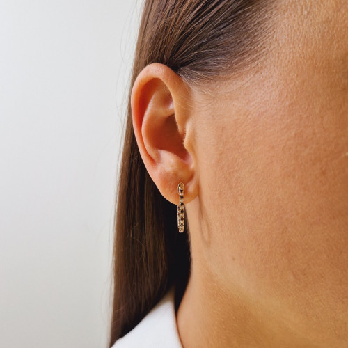 Gold earrings with a black diamond