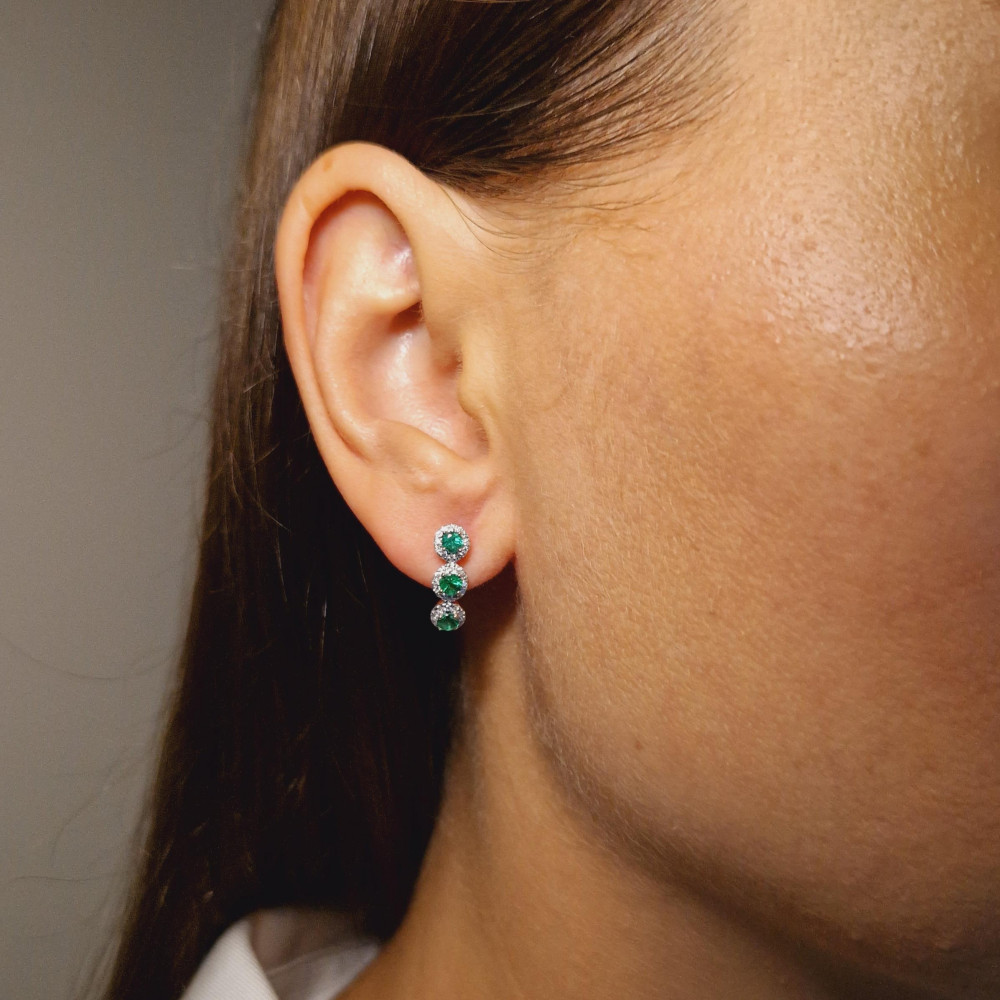 Gold earrings with emerald