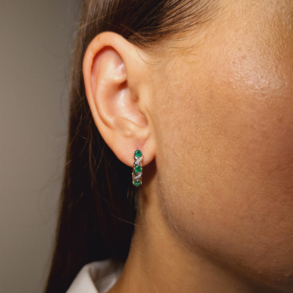 Gold earrings with emerald