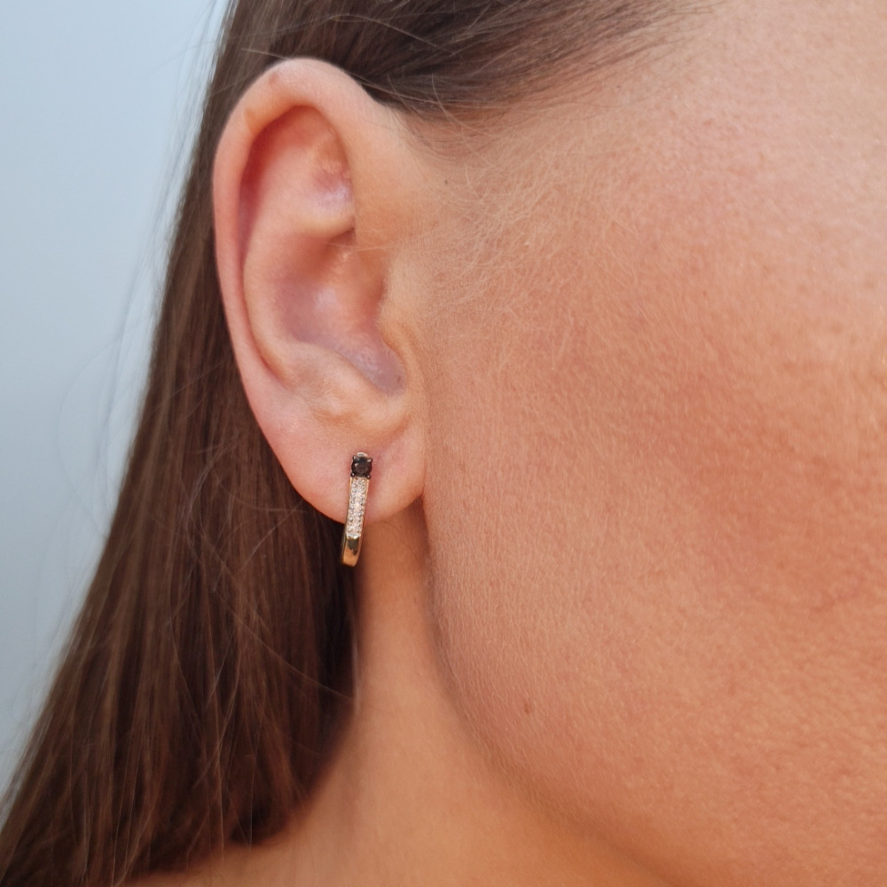 Gold earrings with a black diamond