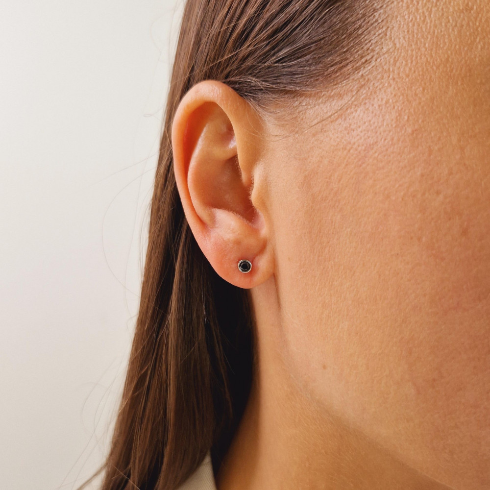 Gold earrings with a black diamond