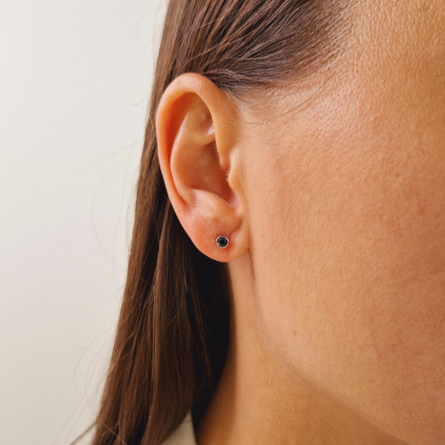 Gold earrings with a black diamond