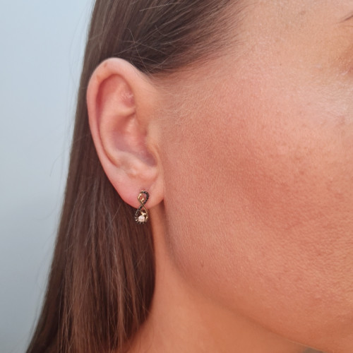 Gold earrings with a black diamond