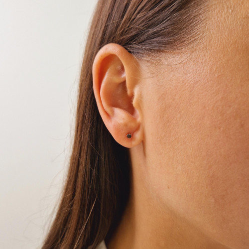 Gold earrings with a black diamond