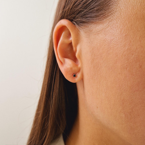 Gold earrings with a black diamond