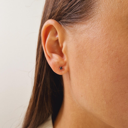 Gold earrings with a black diamond