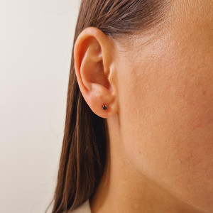 Gold earrings with a black diamond