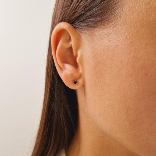 Gold earrings with a black diamond