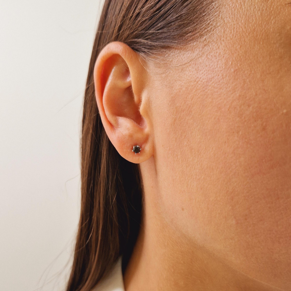 Gold earrings with a black diamond