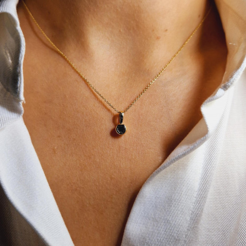 Golden pendant with precious stones