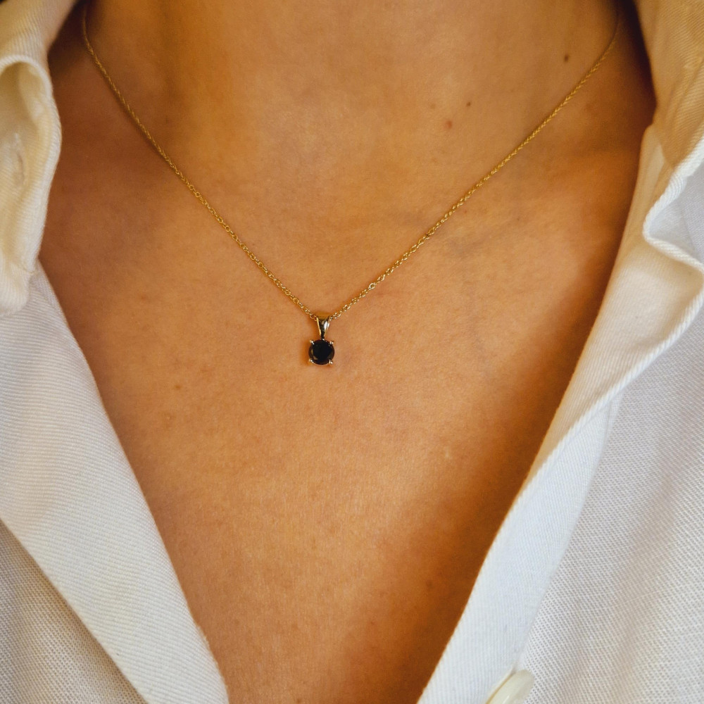 Golden pendant with precious stones